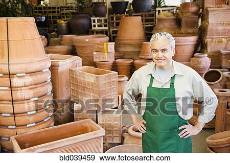 Hispanic man working at garden center View Large Photo Image Stock Photo - Hispanic man working at garden center . Fotosearch