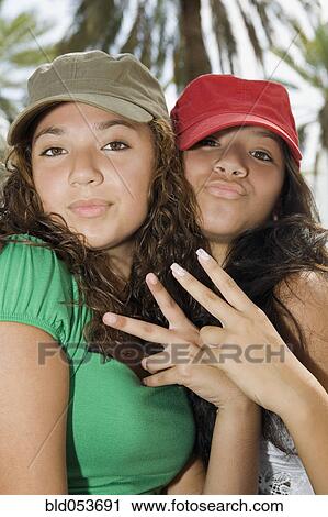 Hispanic teenaged girls making hand gestures View Large Photo Image Stock Image - Hispanic teenaged girls making hand gestures. Fotosearch