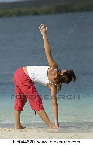Hispanic woman practicing yoga at beach View Large Photo Image Stock Image - Hispanic woman practicing yoga at beach. Fotosearch