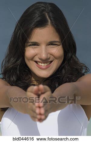 Stock Photograph - Hispanic woman practicing yoga. Fotosearch