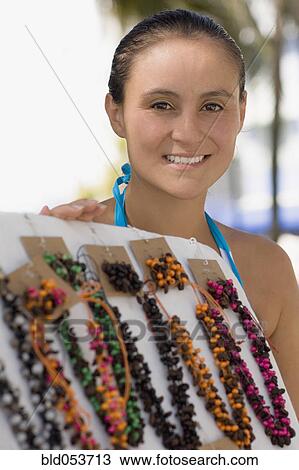 Stock Image - Hispanic woman selling necklaces. Fotosearch