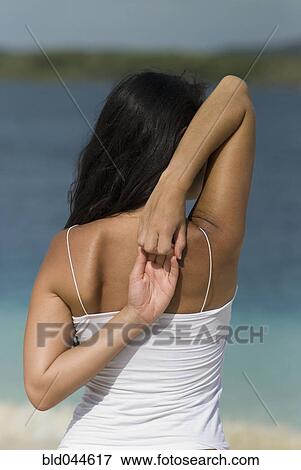 Hispanic woman stretching View Large Photo Image Stock Photo - Hispanic woman stretching. Fotosearch