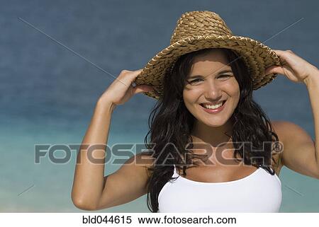 Stock Photography - Hispanic woman wearing straw hat. Fotosearch