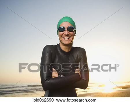 Stock Image - Hispanic woman wearing wetsuit and goggles. Fotosearch