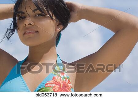 Hispanic woman with hands in hair View Large Photo Image Stock Photo - Hispanic woman with hands in hair. Fotosearch