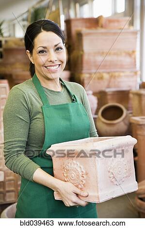 Hispanic woman working at garden center View Large Photo Image Stock Image - Hispanic woman working at garden center. Fotosearch