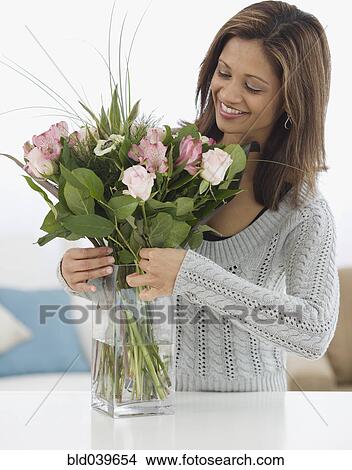 Indian woman arranging flowers View Large Photo Image Picture - Indian woman arranging flowers . Fotosearch