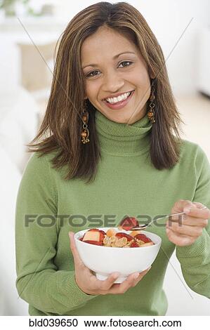 Indian woman eating cereal and fruit View Large Photo Image Stock Image - Indian woman eating cereal and fruit. Fotosearch