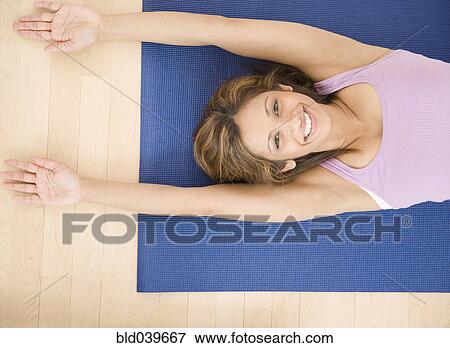 Indian woman laying on yoga mat View Large Photo Image Stock Photo - Indian woman laying on yoga mat. Fotosearch