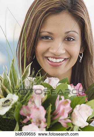Indian woman next to flower bouquet View Large Photo Image Stock Photography - Indian woman next to flower bouquet. Fotosearch
