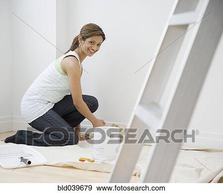 Stock Photo - Indian woman painting indoors. Fotosearch