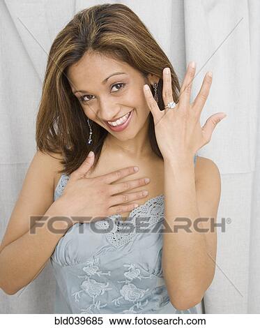 Stock Photography - Indian woman showing off engagement ring. Fotosearch