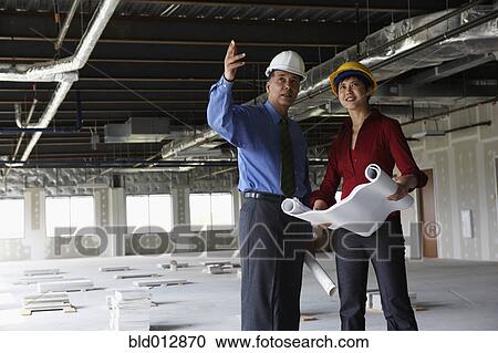 Man and woman at construction site View Large Photo Image Stock Image - Man and woman at construction site. Fotosearch