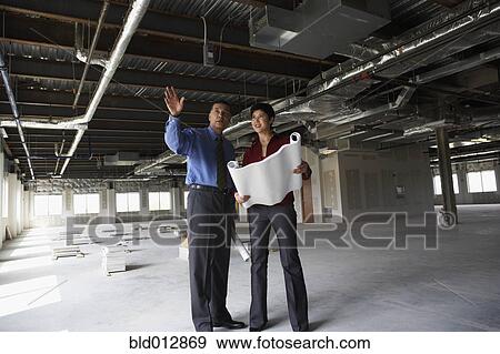 Man and woman at construction site View Large Photo Image Stock Photo - Man and woman at construction site. Fotosearch