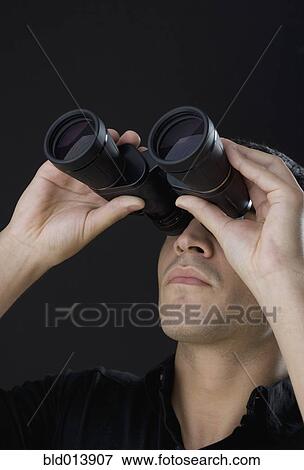 Stock Photo - Man looking through binoculars. Fotosearch