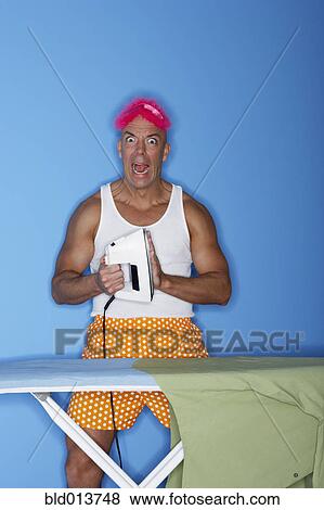Man with hand on hot iron View Large Photo Image Stock Photo - Man with hand on hot iron. Fotosearch