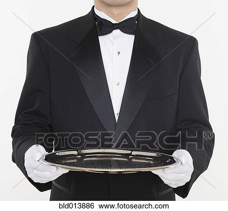 Stock Photograph - Mid section of male waiter holding tray. Fotosearch