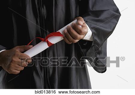 Mid section of man in graduation gown holding diploma View Large Photo Image Stock Photograph - Mid section of man in graduation gown holding diploma. Fotosearch