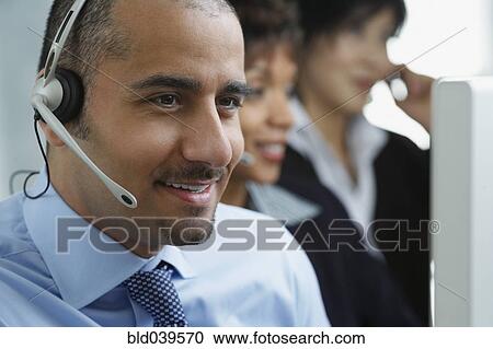 Stock Image - Middle Eastern businessman wearing headset. Fotosearch
