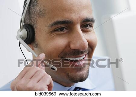 Stock Photo - Middle Eastern businessman wearing headset. Fotosearch