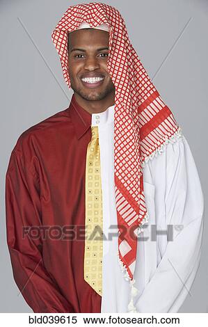 Stock Photography - Middle Eastern man wearing traditional dress and business attire. Fotosearch
