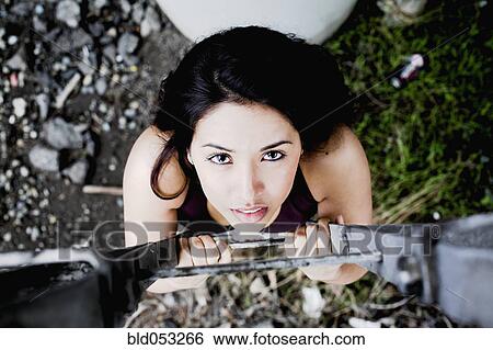 Middle Eastern woman climbing up ladder View Large Photo Image Stock Photograph - Middle Eastern woman climbing up ladder. Fotosearch