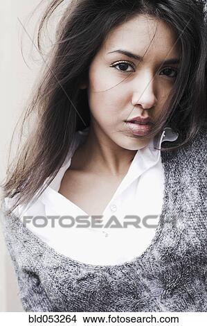 Picture - Middle Eastern woman with hair blowing. Fotosearch