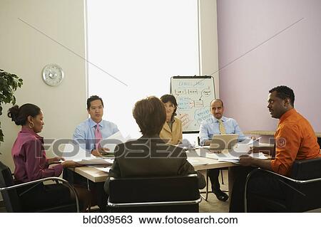 Stock Image - Multi-ethnic businesspeople at meeting. Fotosearch