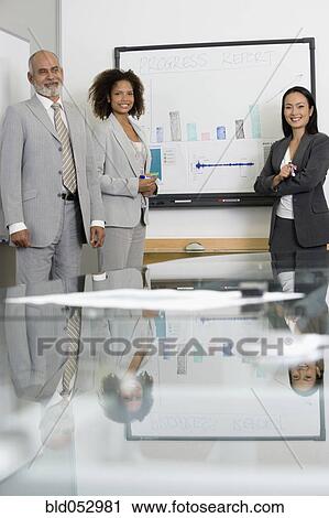 Multi-ethnic businesspeople next to graph View Large Photo Image Stock Image - Multi-ethnic businesspeople next to graph. Fotosearch