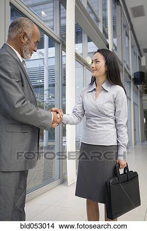 Picture - Multi-ethnic businesspeople shaking hands . Fotosearch