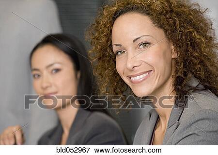 Stock Photo - Multi-ethnic businesswomen at meeting. Fotosearch