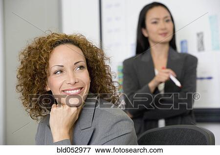 Stock Photo - Multi-ethnic businesswomen at meeting. Fotosearch