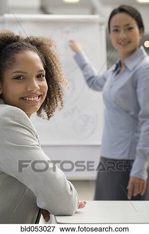 Stock Photo - Multi-ethnic businesswomen at meeting. Fotosearch