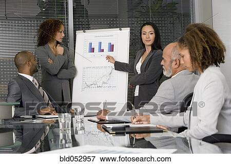 Multi-ethnic businesswomen giving presentation View Large Photo Image Stock Photo - Multi-ethnic businesswomen giving presentation. Fotosearch