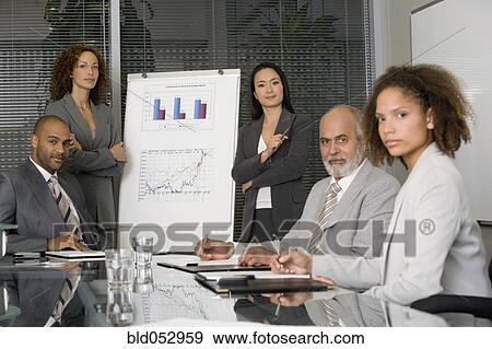 Stock Photo - Multi-ethnic businesswomen giving presentation. Fotosearch