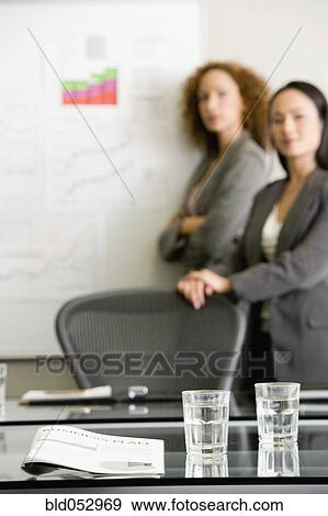 Multi-ethnic businesswomen giving presentation View Large Photo Image Stock Photo - Multi-ethnic businesswomen giving presentation. Fotosearch
