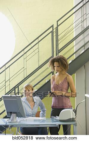 Multi-ethnic businesswomen looking at computer View Large Photo Image Stock Photo - Multi-ethnic businesswomen looking at computer. Fotosearch