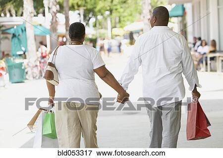 Multi-ethnic couple holding hands View Large Photo Image Stock Photo - Multi-ethnic couple holding hands. Fotosearch