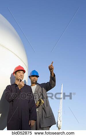 Multi-ethnic male construction workers pointing View Large Photo Image Stock Photography - Multi-ethnic male construction workers pointing. Fotosearch