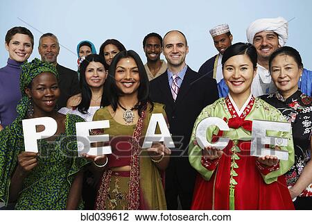 Stock Image - Multi-ethnic people holding the word PEACE . Fotosearch