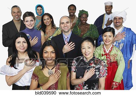 Stock Image - Multi-ethnic people in traditional dress holding hand on heart. Fotosearch