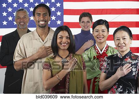 Multi-ethnic people standing in front of American flag View Large Photo Image Stock Photo - Multi-ethnic people standing in front of American flag. Fotosearch