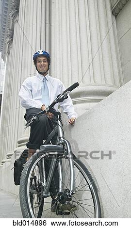 Portrait of businessman on bike View Large Photo Image Stock Photograph - Portrait of businessman on bike. Fotosearch