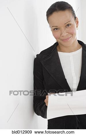 Stock Photo - Portrait of businesswoman reading paperwork. Fotosearch