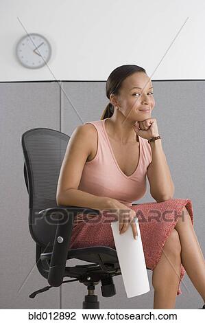 Portrait of businesswoman sitting in office View Large Photo Image Stock Image - Portrait of businesswoman sitting in office. Fotosearch