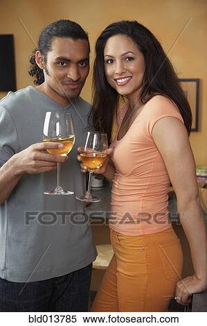Stock Photography - Portrait of couple drinking white wine. Fotosearch