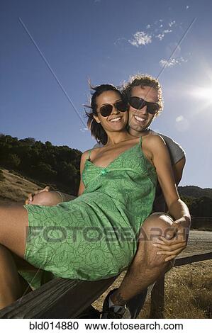 Stock Image - Portrait of couple wearing sunglasses. Fotosearch