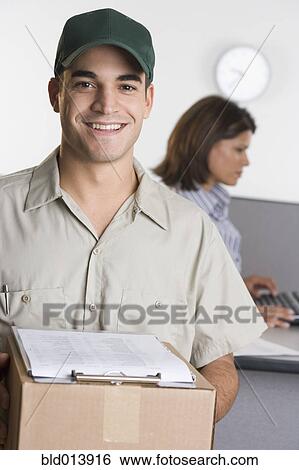 Portrait of delivery man with box View Large Photo Image Stock Photograph - Portrait of delivery man with box. Fotosearch