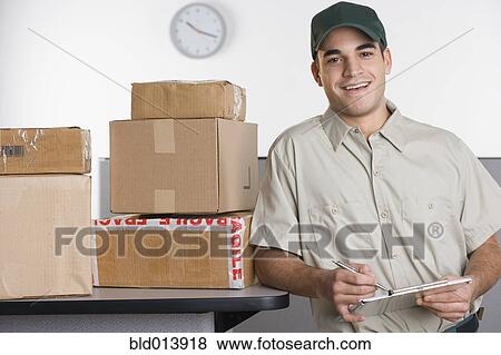 Portrait of delivery man with stack of boxes View Large Photo Image Stock Photo - Portrait of delivery man with stack of boxes. Fotosearch