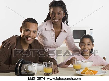 Picture - Portrait of family at breakfast table. Fotosearch